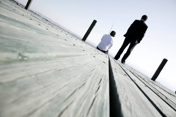 Empty lake pier stretching out to sea. Sunny summer day, bright natural light, no people