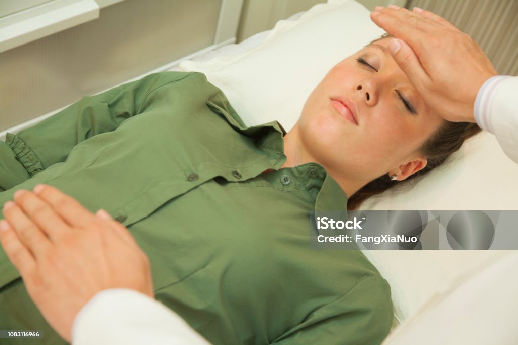Doctor's hands hovering over patient Balance Stock Photo