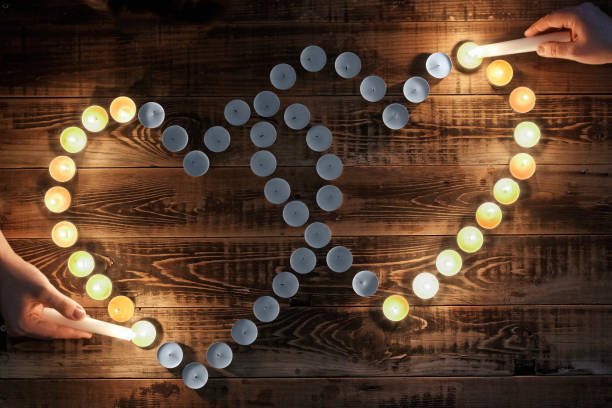 Happy Valentine's Day. Cute background for the design of a romantic holiday. Love. Small burning candles in the dark.