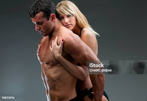 Young Woman Holding Nude Muscular Man Xxxl Stock Photo - Download Image Now - Young Couple, Abdominal Muscle, Adulation