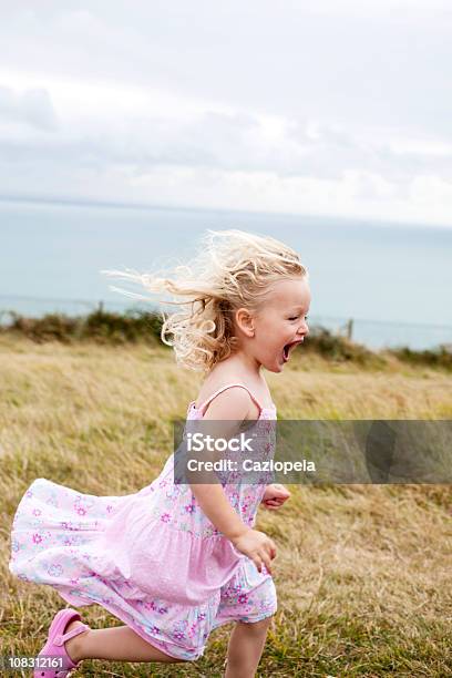 Niña Corriendo En El Campo Foto de stock y más banco de imágenes de Condado de Kent - Inglaterra - Condado de Kent - Inglaterra, Escena rural, Niño