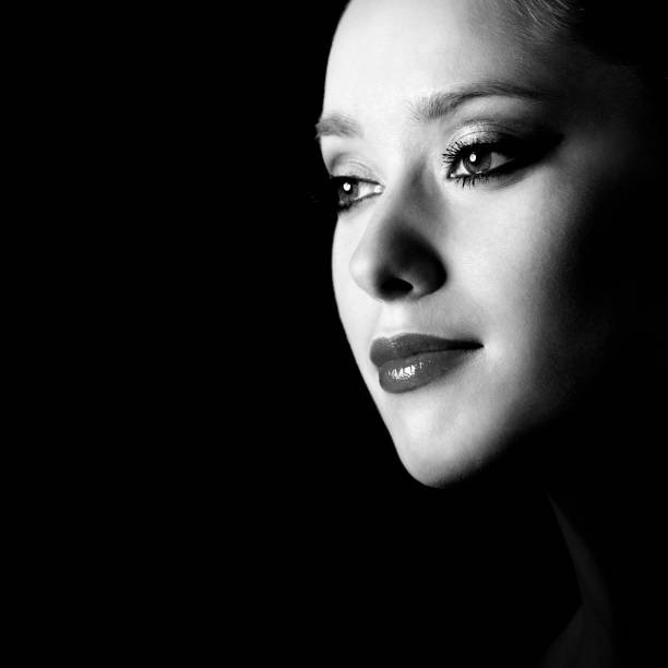 istock Young woman profile portrait against black background 108312252