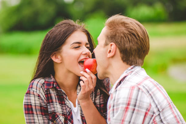 istock The man and woman bit an apple 1083123798