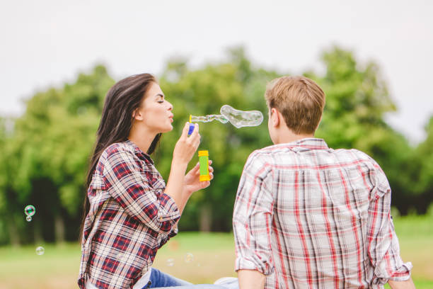 istock The couple blow bubbles on the nature 1083123876