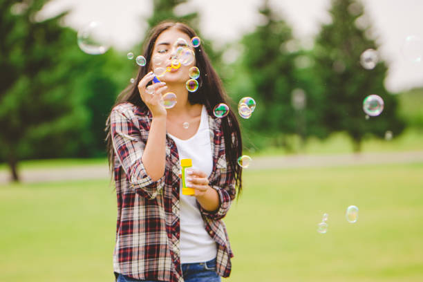 istock The woman blows bubbles on the nature 1083123888