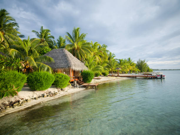 Tahiti, French Polynesia - May 30, 2011:  An overwater Tahitian bungalow at sunset.