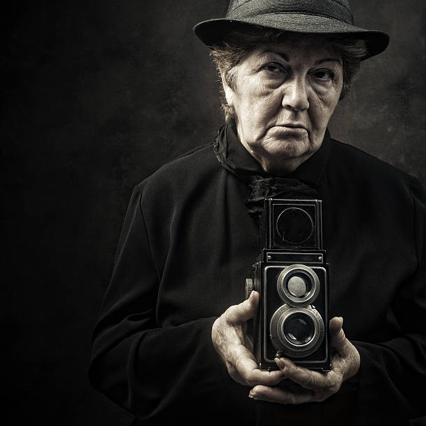 senior lady with a vintage viewfinder camera