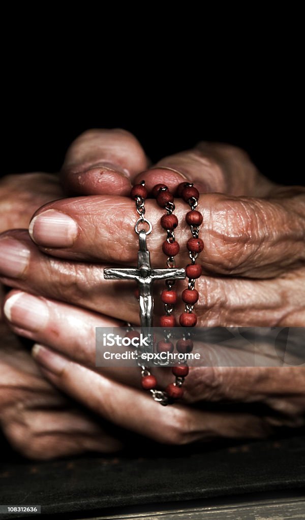 Praying with Rosary Beads Praying with Rosary Beads and Bible.

Cross processed, soft with slight grain. Prayer Beads Stock Photo