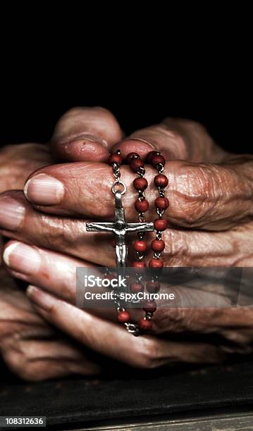 Praying With Rosary Beads Stock Photo - Download Image Now - Prayer Beads, Bead, Bible