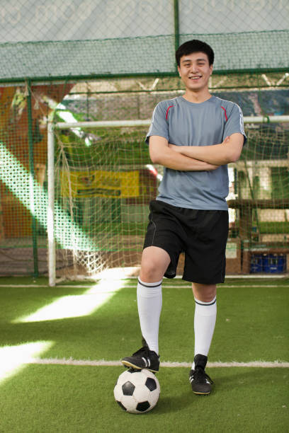 istock Chinese soccer player standing on pitch 1083127280