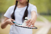 Chinese girl holding badminton racket and shuttlecock