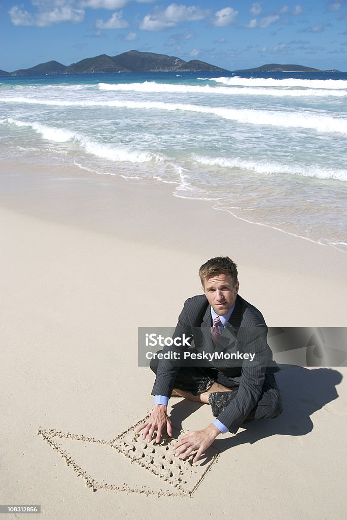 Empresário sentado na praia com areia portátil escrita - Royalty-free Encalhado Foto de stock