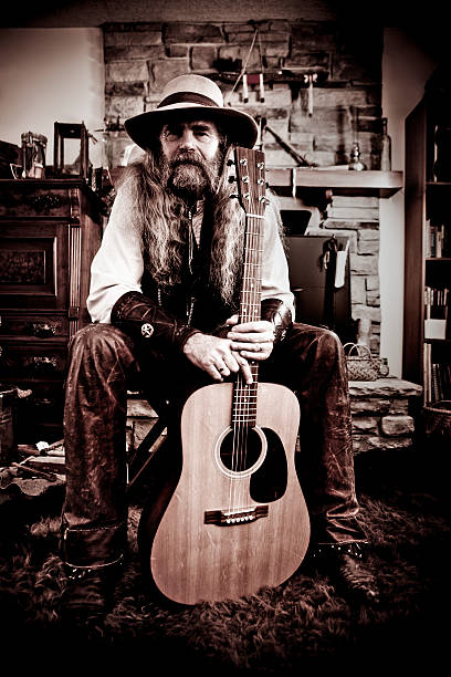 Old-Fashioned Western Cowboy Posing with Guitar stock photo