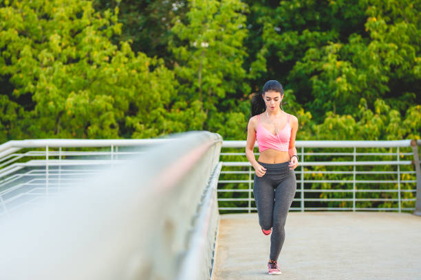 istock The sportswoman running on the bridge 1083138462