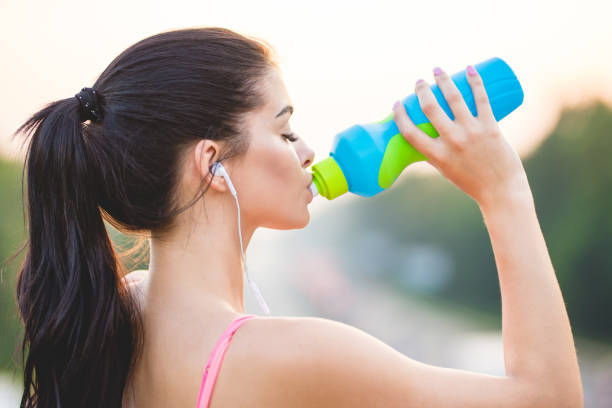 istock The sportswoman drinks a water on the bridge 1083139478