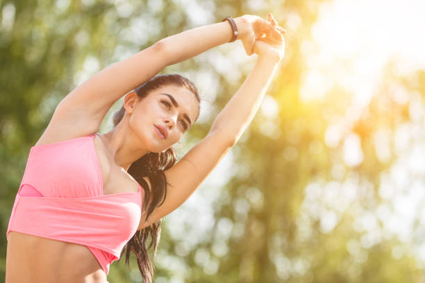 istock The sportswoman doing exercise on the sunshine background 1083139696