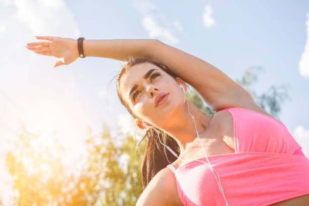 istock The sportswoman stretching on the sunlight bakground 1083139774