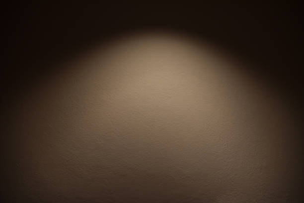 istock light on wall - the lamp shines with warm light on brown wall / light effect 1083139794