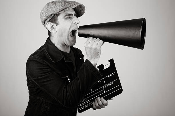 istock Film Director Shouting With Megaphone While Holding Film Slate 108314001
