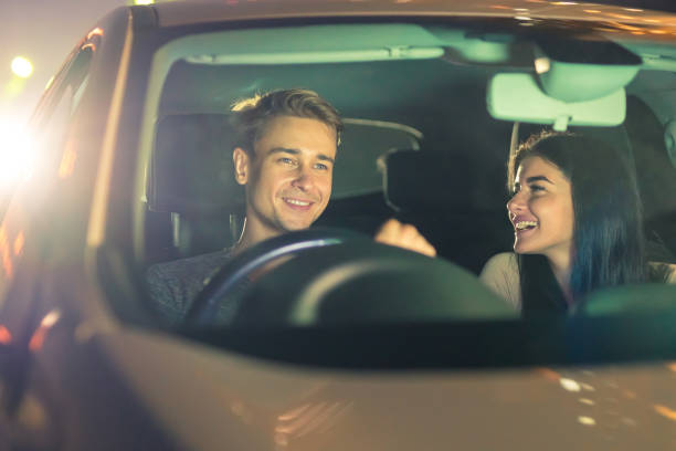 istock The happy couple drive a car. evening night time 1083140146