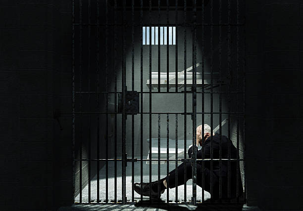 Businessman sitting in Jail stock photo