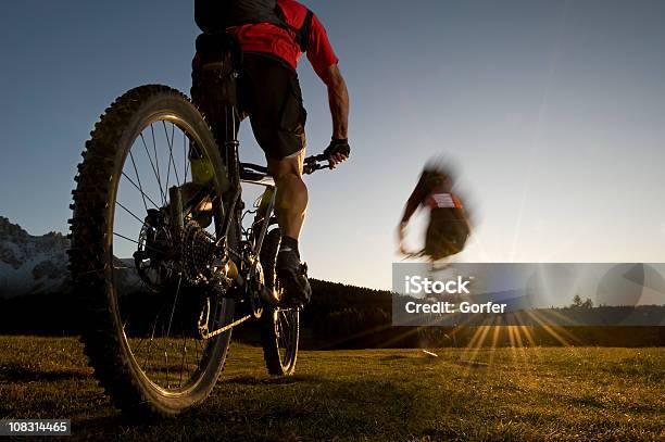 Mountainbiker In Rapidlyer Goes Direction Sunset Stock Photo - Download Image Now - Cycling, Mountain, Bicycle