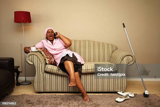 Maid Taking A Break Stock Photo - Download Image Now - African Ethnicity, Housekeeping Staff, Apron