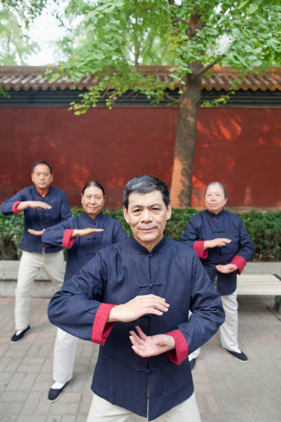 istock Chinese people practicing taiji in park 1083153546