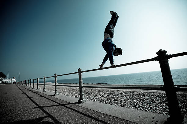 Parkour and freerunning rail handstand stock photo