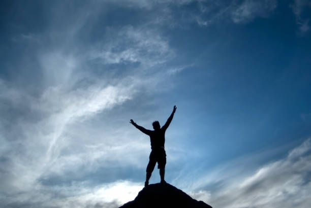 istock silhouette man arms raised into sky abstract 108315387