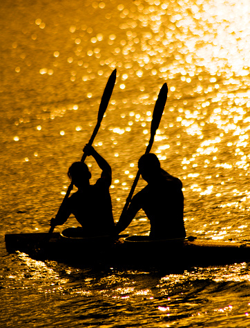 Sillhouette of two young ladies during kayaking activity