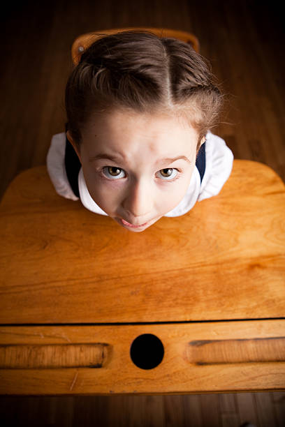 red-haired girl doing homework at the table school subject education. High quality photo