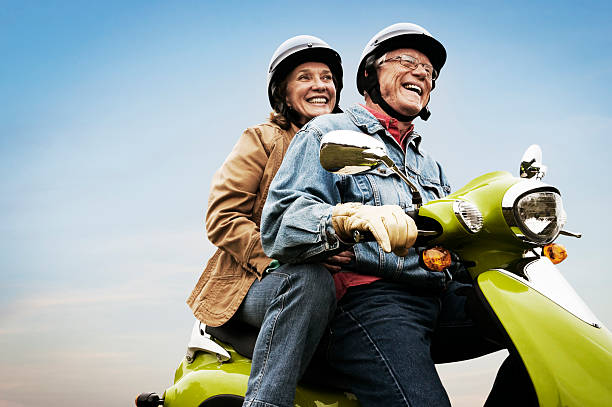 Happy Active Senior Couple on Scooter stock photo