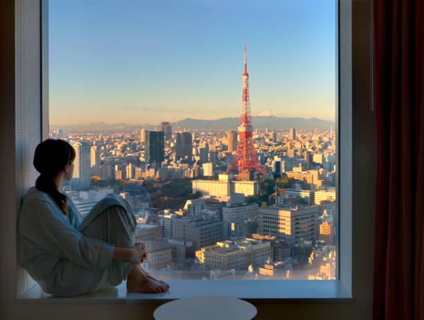 Young Woman Viewing Tokyo at Sunrise stock photo