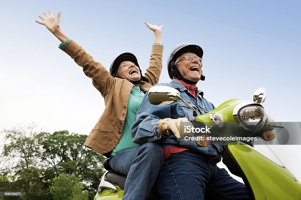 Senior Couple on Scooter Senior couple having fun riding motor scooter. Horizontal shot. Senior Adult Stock Photo