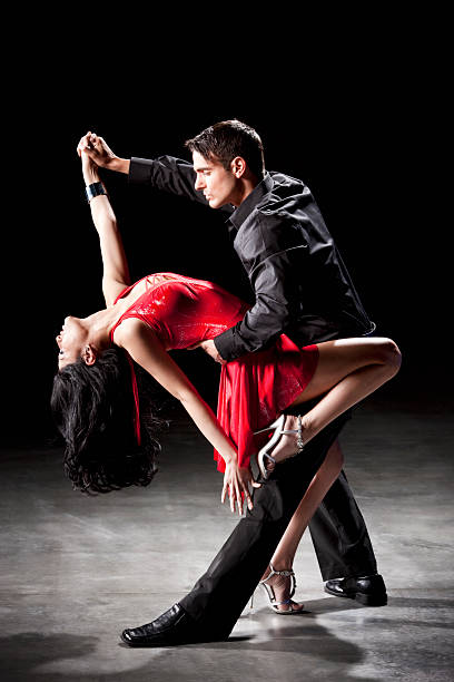 Latin Dance: Tango Dip An attractive hispanic couple dancing the tango in a dance performance or competition. tango dance stock pictures, royalty-free photos & images