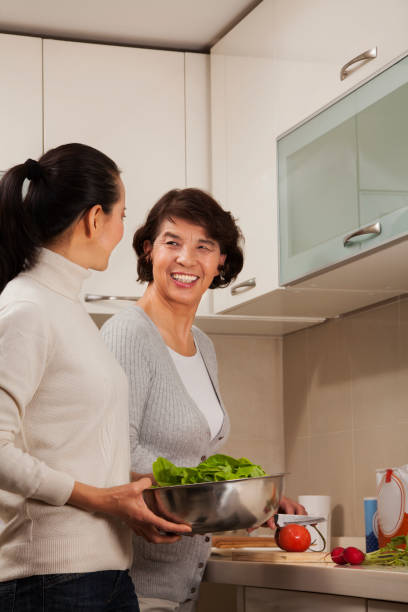 istock Chinese mother and daughter cooking in kitchen 1083170472