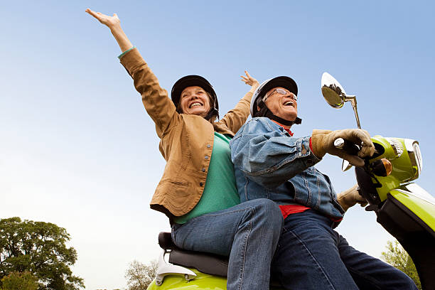 Senior Couple Riding Scooter