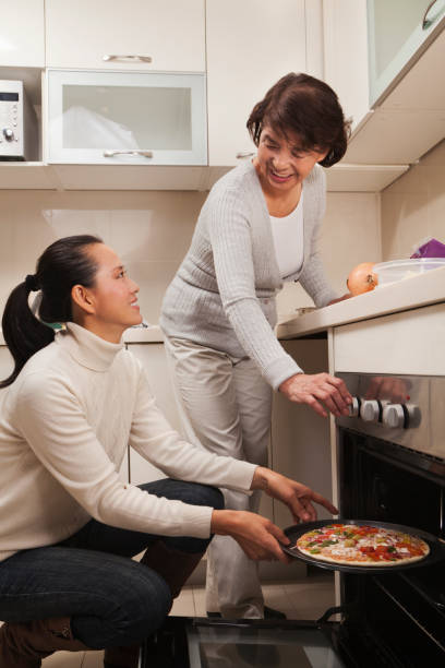 istock Chinese mother and daughter cooking in kitchen 1083171486