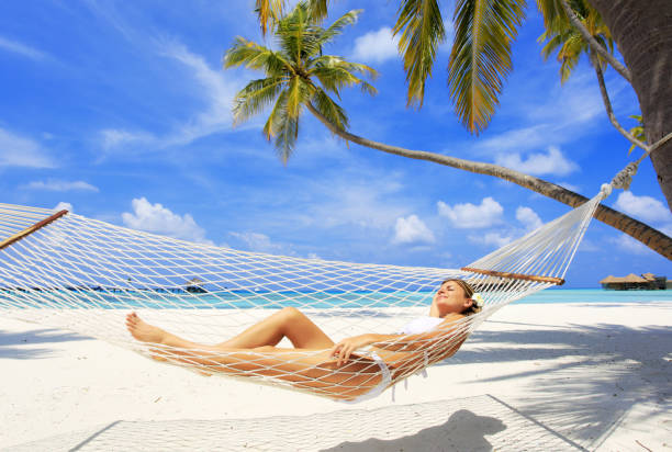 istock Young woman relaxing in a hammock 108317154