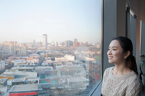 Chinese businesswoman looking out window