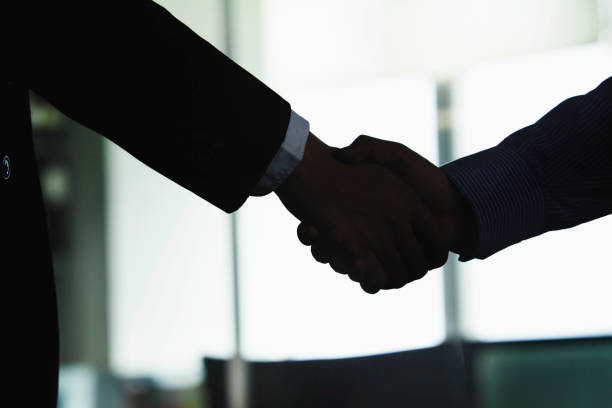 istock Chinese business people shaking hands 1083200610
