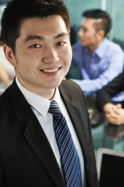 istock Chinese businessman smiling in meeting 1083200676
