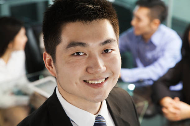 istock Chinese businessman smiling in meeting 1083200712