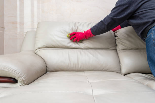 istock side view man cleaning leather sofa at home with wet towel 1083206144