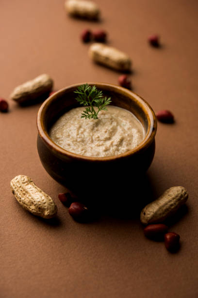 istock Healthy Peanut chutney made using Groundnut / Shengdana or mungfali. served in a small bowl with raw whole. Selective focus 1083213732