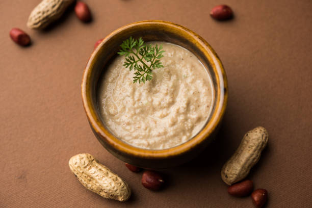 istock Healthy Peanut chutney made using Groundnut / Shengdana or mungfali. served in a small bowl with raw whole. Selective focus 1083213736