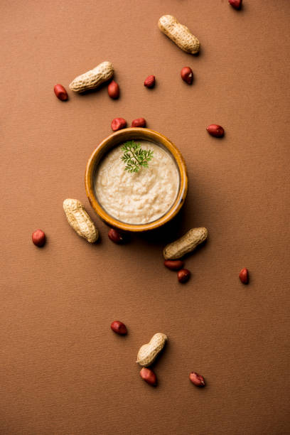 istock Healthy Peanut chutney made using Groundnut / Shengdana or mungfali. served in a small bowl with raw whole. Selective focus 1083213744