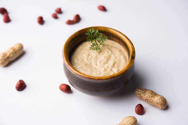 istock Healthy Peanut chutney made using Groundnut / Shengdana or mungfali. served in a small bowl with raw whole. Selective focus 1083213780