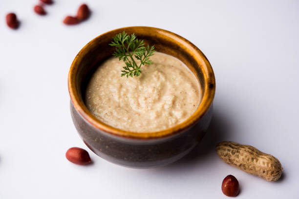 istock Healthy Peanut chutney made using Groundnut / Shengdana or mungfali. served in a small bowl with raw whole. Selective focus 1083213818